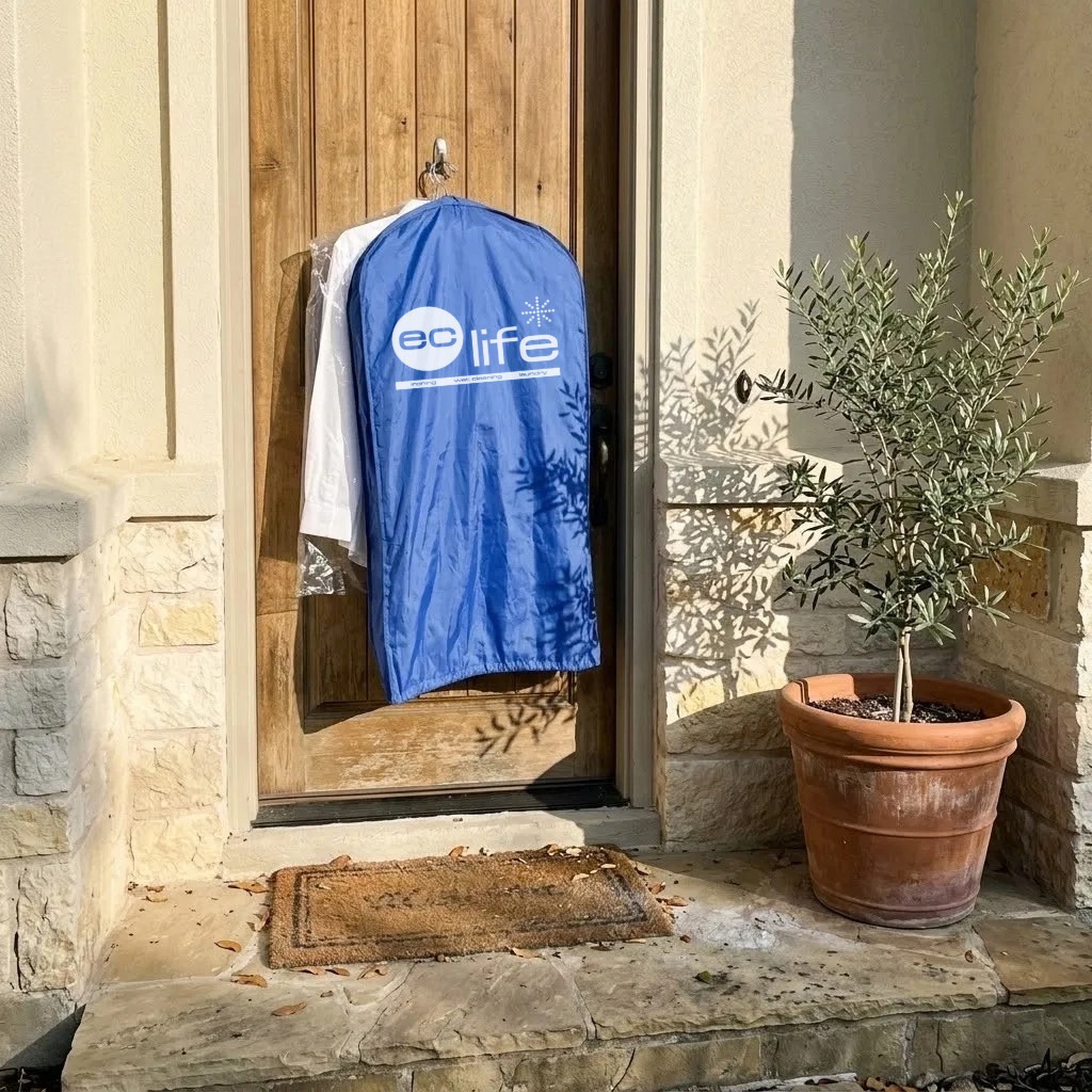 Freshly cleaned garments delivered in an EcLife garment bag, hung on the customer's front door